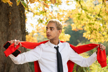 Portrait of young man in park with red sweater