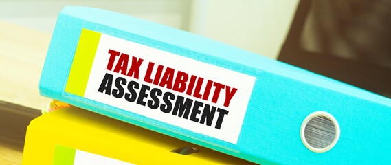 Two office folders with text TAX LIABILITY ASSESSMENT