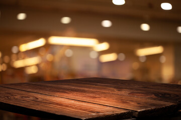 Empty wooden tabletop with blurred abstract bokeh cafe background. For product display or key...