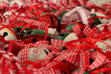 Shallow depth of field image of crotal bells or sleigh bells with focus on the bottom left third, The green  and red bell. Magical Christmas image.
