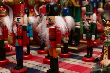 Close up of a nut cracker soldier Christmas decoration with more soldiers in soft focus behind.