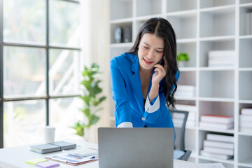 Confident Asian Businesswoman Talking on Phone in Modern Office. Corporate Communication and Technology Concept