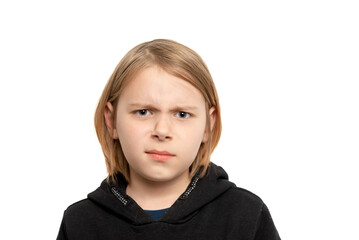 A discontented young boy, aged ten, with long locks, expressing displeasure against a clean white background