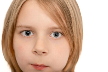 Close-up portrait of a ten-year-old boy with flowing locks, his youthful essence captured against a pristine white backdrop