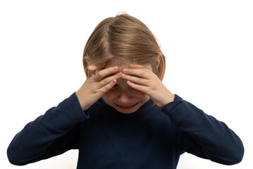 Young boy deep in thought, holding his head in his hands, captured in a moment of intense...