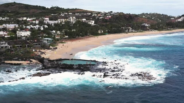 Aerial drone view of the coast of Boucan Canot with its natural pool on a cloudy day, Boucan Canot, Saint-Paul, Reunion.