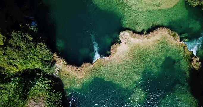 Stunning aerial drone footage of Krka National Park waterfalls in Croatia, captured by a Mavic Pro. This natural paradise showcases cascading waterfalls surrounded by lush green forests, ideal for tra