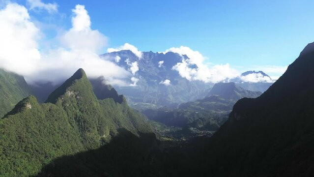 Panoramic aerial drone view of Cirque de Salazie with Piton d'Anchaing and Piton des Neiges in the background, Saint Andre, Reunion.