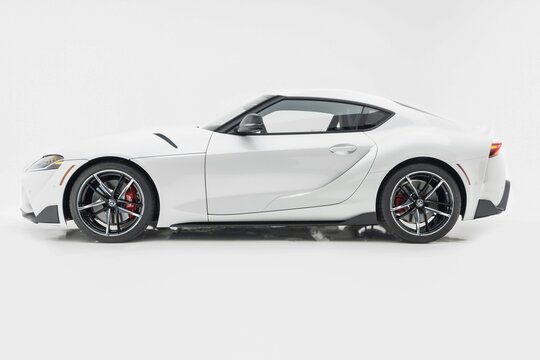 White Toyota Supra side view isolated on white background - High Resolution Image