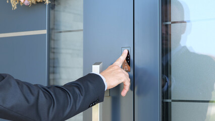 Business man using fingerprint to unlock smart key home entrance - obrazy, fototapety, plakaty