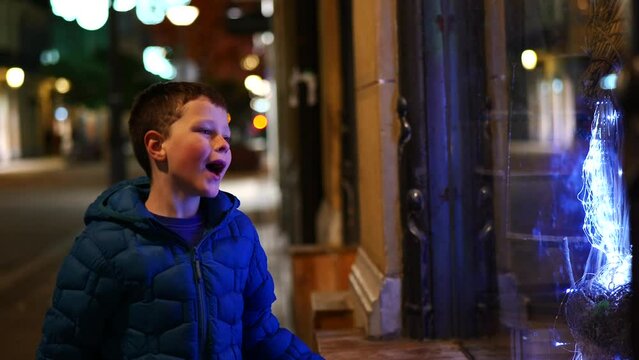 adorable little boy having fun on the street at christmas time