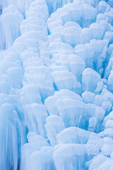 Obraz premium Water falls forming intricate icicle formations in Caucasus, Russia. Close-up, detail