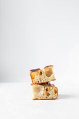 homemade olive focaccia on a white countertop, Flatlay of focaccia with green olive topping, fresh homemade focaccia bread