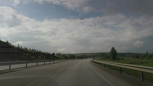 highway road in the countryside, roadside and asphalt, green trees and mountains 