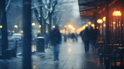 Blurred image of people walking on the street at night with snowfall.