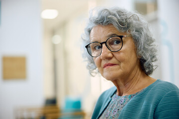 Portrait of senior woman in waiting room at doctor's office.