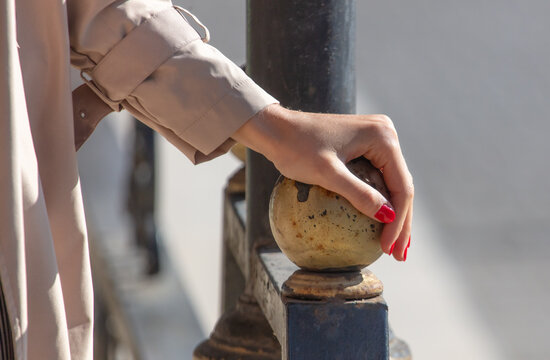 Close-up of a girl's hand on a metal railing