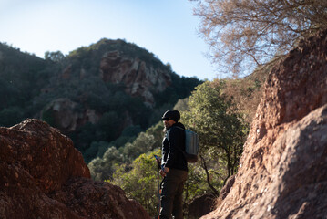 Obraz premium Middle-aged man contemplates the landscapes of the Garraf Natural Park while walking along the trails of a mountain.