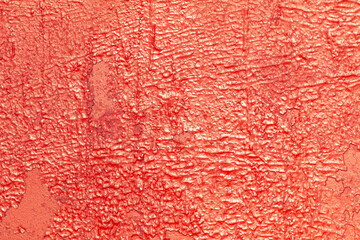 Cracked rusty metal painted with red paint as an abstract background. Texture