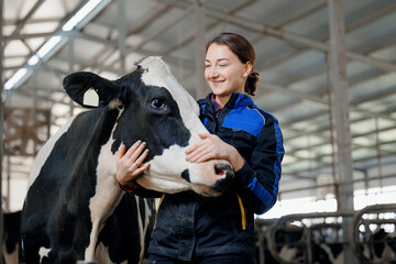 Happy young woman farm worker hugging cow as sign of concern for animal health care. Concept...