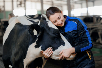 Concept agriculture cattle livestock farming industry. Farmer Happy young woman hugging cow,...