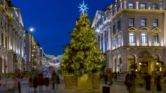 Evening time lapse view of the beautiful christmas tree at Waterloo Place and fairy lights at Regent Street, St James's, London