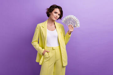 Photo of confident financial ceo brown bob hair woman young age holding dollars usd salary per day...