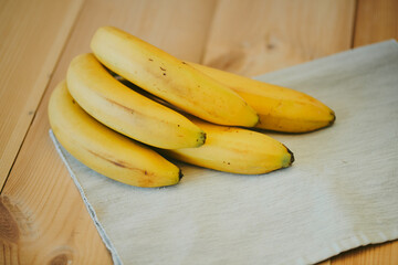 Close-up of a bunch of bananas on a wooden kitchen table background