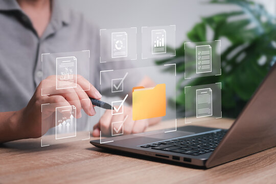 Enterprise Resource Planning, Document management, and business-grown data report concept. Businessman use laptops and select business data folders financial information business-grown graphs