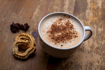 Coffee with milk with cinnamon and cookies