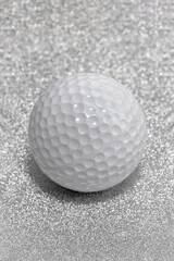 Golf ball on a Christmas glitter background.