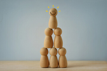 Human pyramid made of wooden pawn - Concept of teamwork and success - 689689836