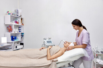 cosmetologist doing anti aging procedure in beauty salon