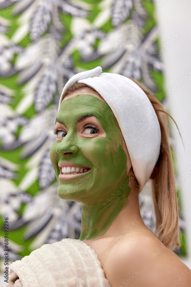 Wall mural beautiful woman with green alginate mask on face