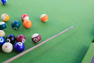 Billiard balls on a green billiard table.