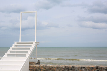 Open door gate with stairs to the sea and sky.