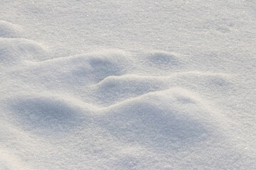 Uneven ground surface covered with snow, snow texture