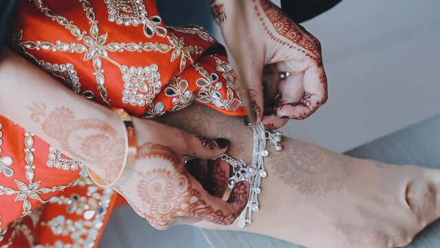 Closeup shot of women ankle wearing silver anklets..