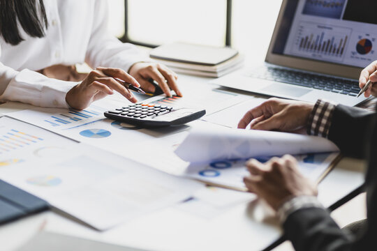 Business advisory meeting to analyze financial charts and review accounting documents.