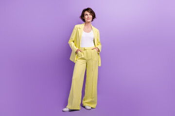 Full length photo of dreamy thoughtful woman dressed yellow jacket looking empty space isolated...