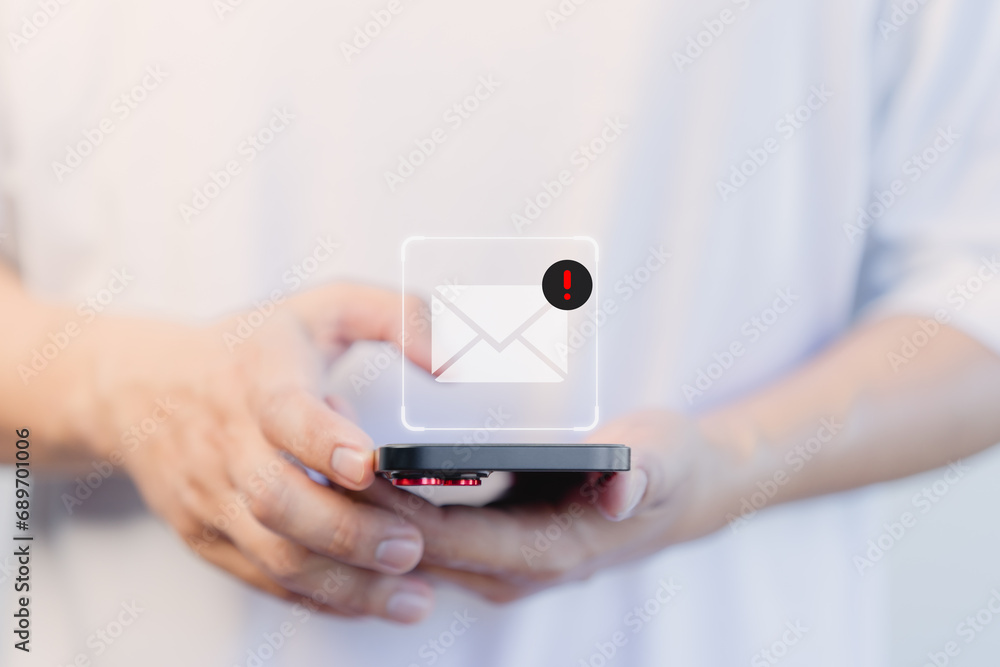 Poster User hand using a mobile phone with an email icon, Email alert with a caution warning sign for notification error. Security protection on the internet, junk mail, and compromised information.