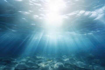 The sun shines through the water in the ocean