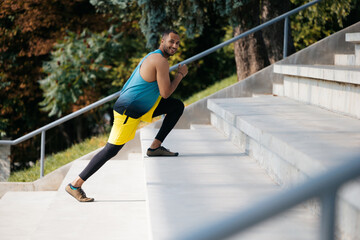 Dark-skinned athlete exercising on the stairs