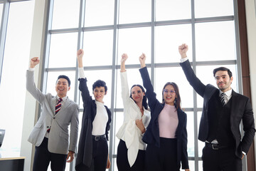 Portrait of five cheerful happy businesspeople, group of businessmen and businesswomen confident raising hands up to celebrate success, business team collaboration power of teamwork.