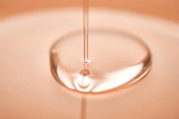 Fotobehang A juicy drop of gel on a Peach Fuzz background. © Marevgenna