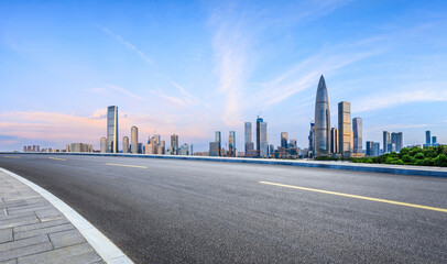 Obraz premium Asphalt road and urban skyline with modern buildings at sunrise in Shenzhen, Guangdong Province, China.