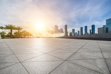 Empty square floors and city skyline with modern buildings scenery at sunset in Zhuhai, China.