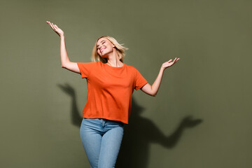 Photo portrait of lovely young lady raise hands elegant posing dance dressed stylish orange garment...