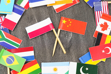 Fototapeta na wymiar The concept is diplomacy. In the middle among the various flags are two flags - China, Poland