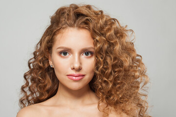 Glorious redhead model woman with long healthy wavy hairstyle, perfect clean fresh skin on white background, fashion beauty concept